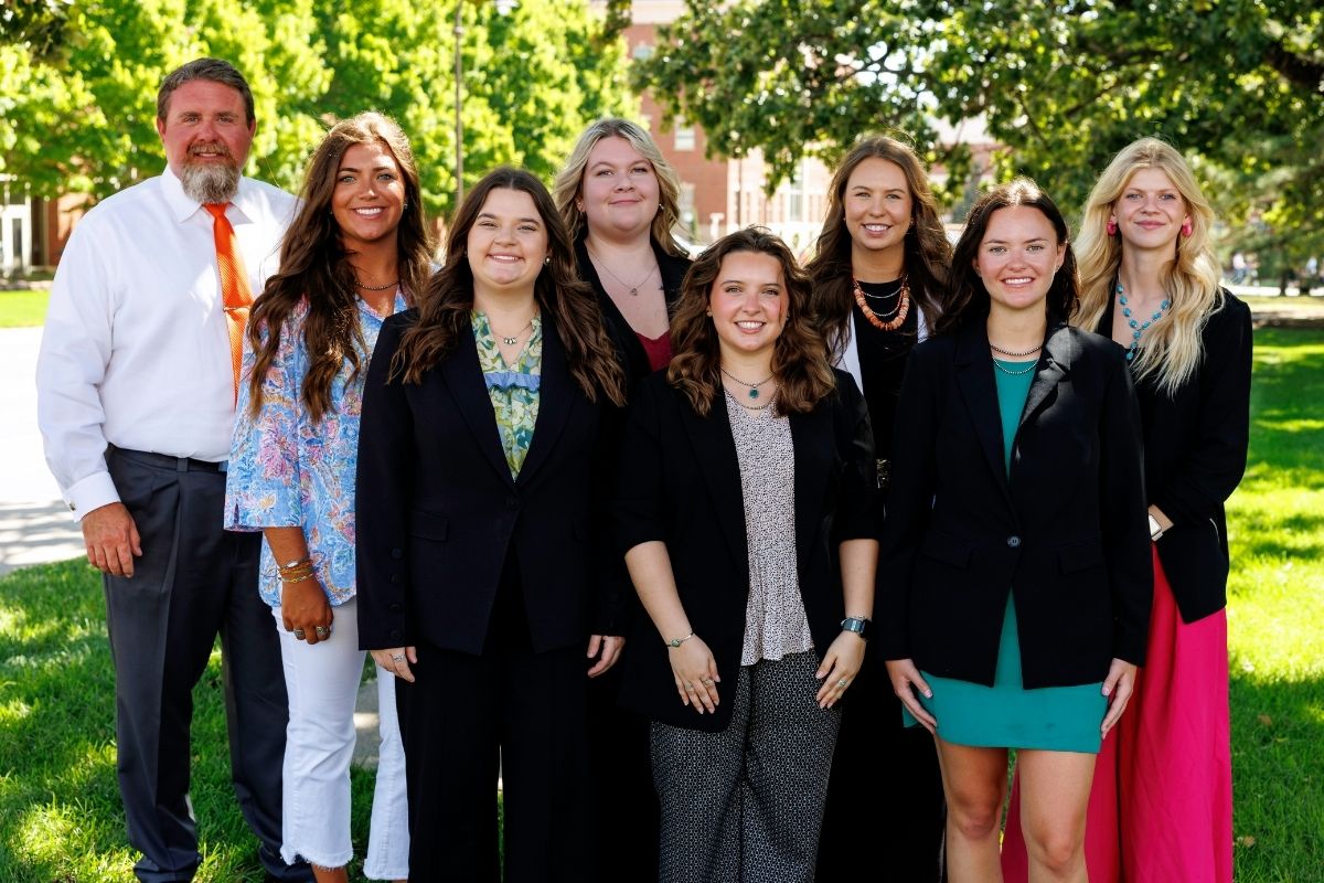 A cohort of student teachers standing for a group photo.