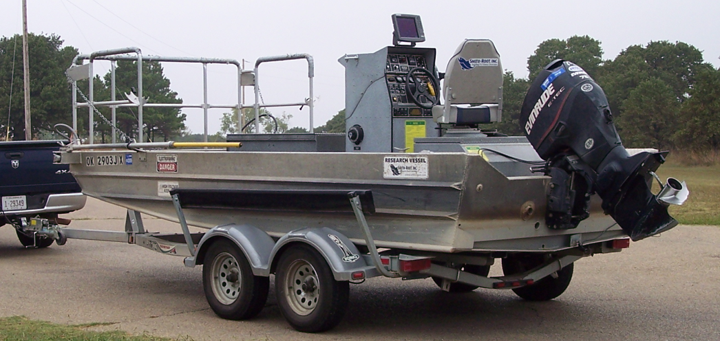 Smith Root electrofishing boat being pulled on a trailer.
