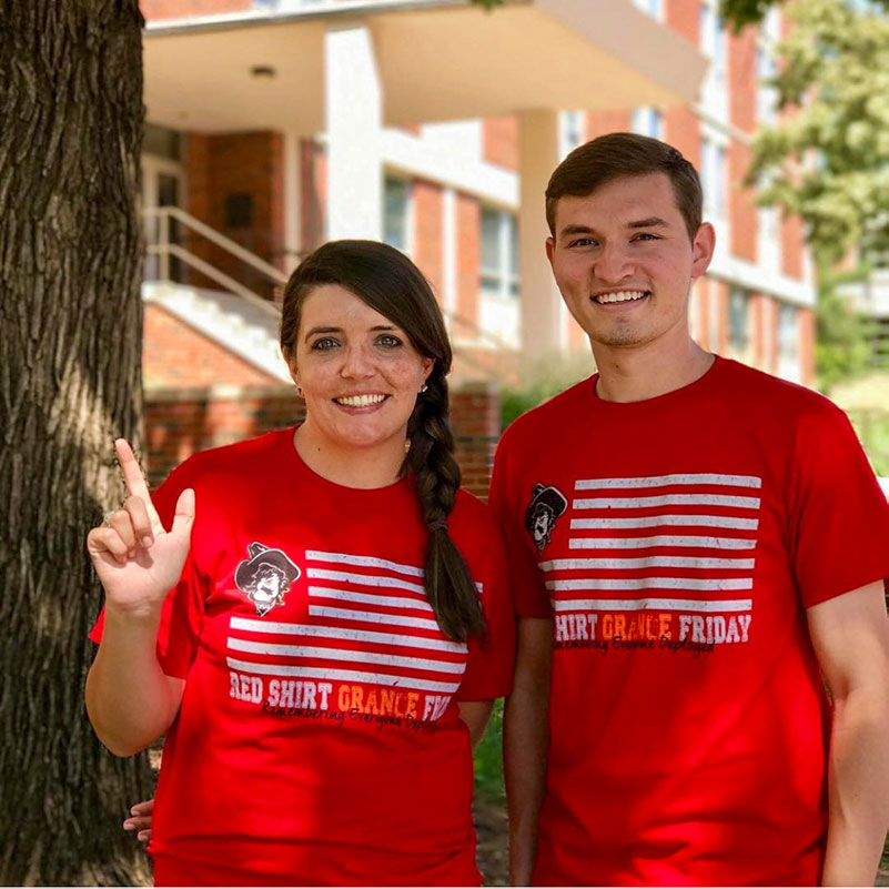 teaser-rsof-800-800.jpg Two students wearing shirts to celebrate Red Shirt, Orange Friday, an awareness event for deployed military.