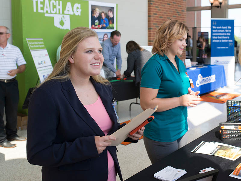 Women passing out information at the Career Fair.