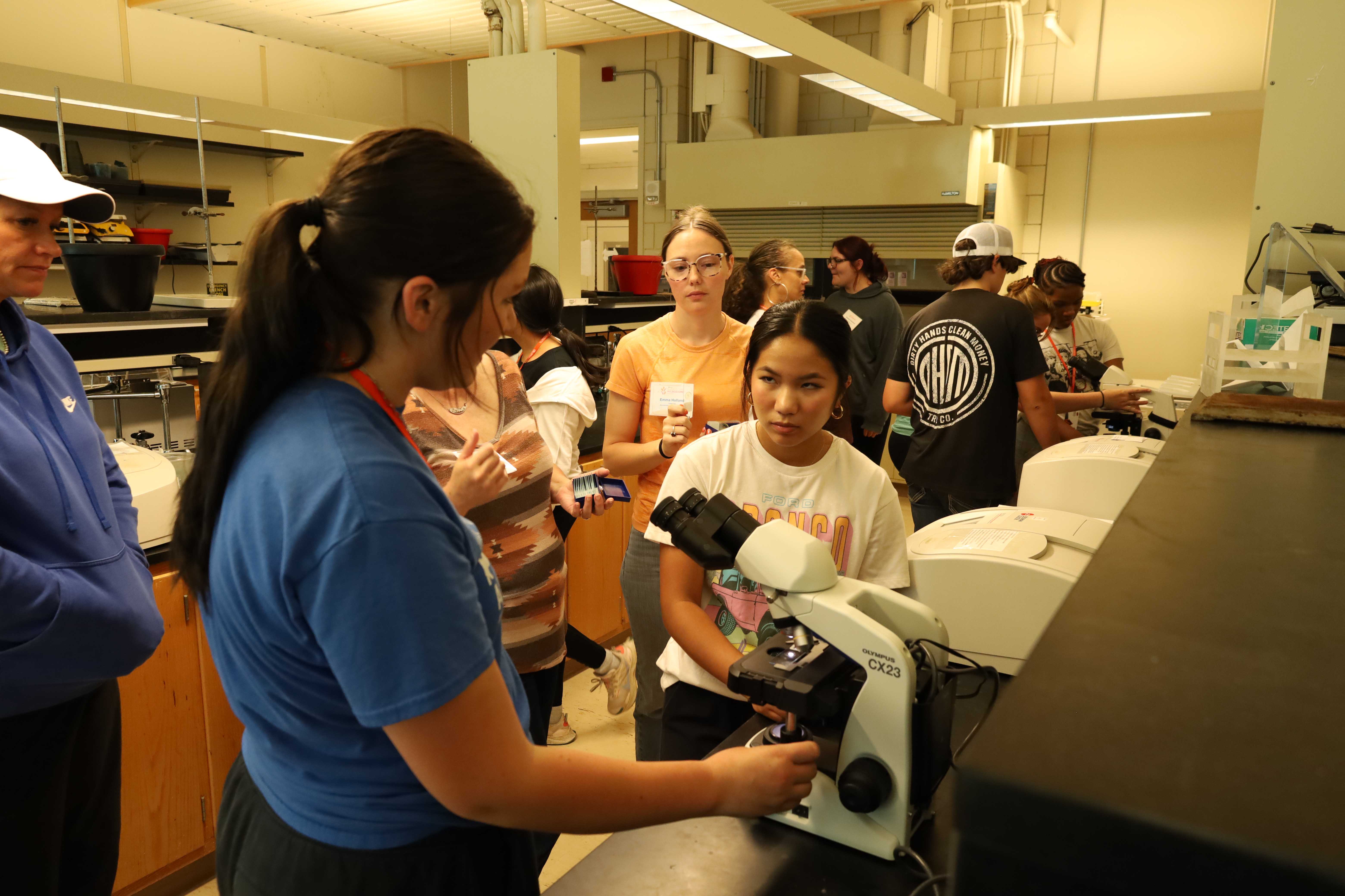 Students learning about and using microscopes Students learning about and using microscopes