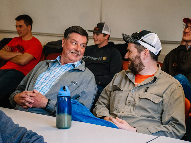 Two faculty members laugh together Two faculty members laugh together