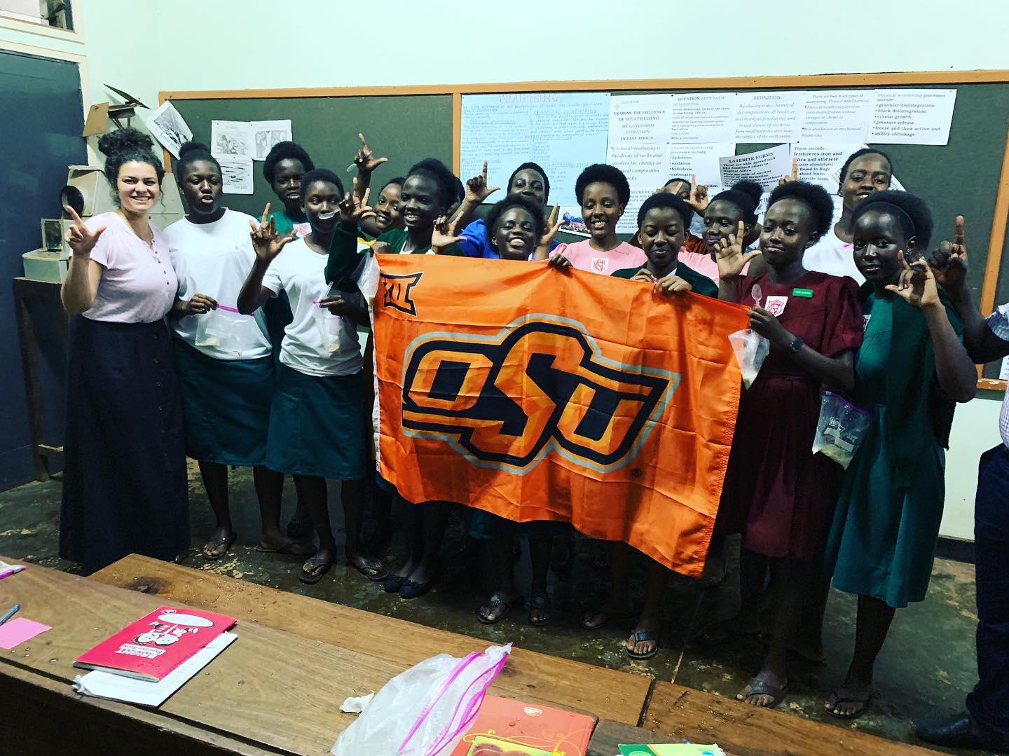 OSU student in a photo with a group of students at a school in Africa.