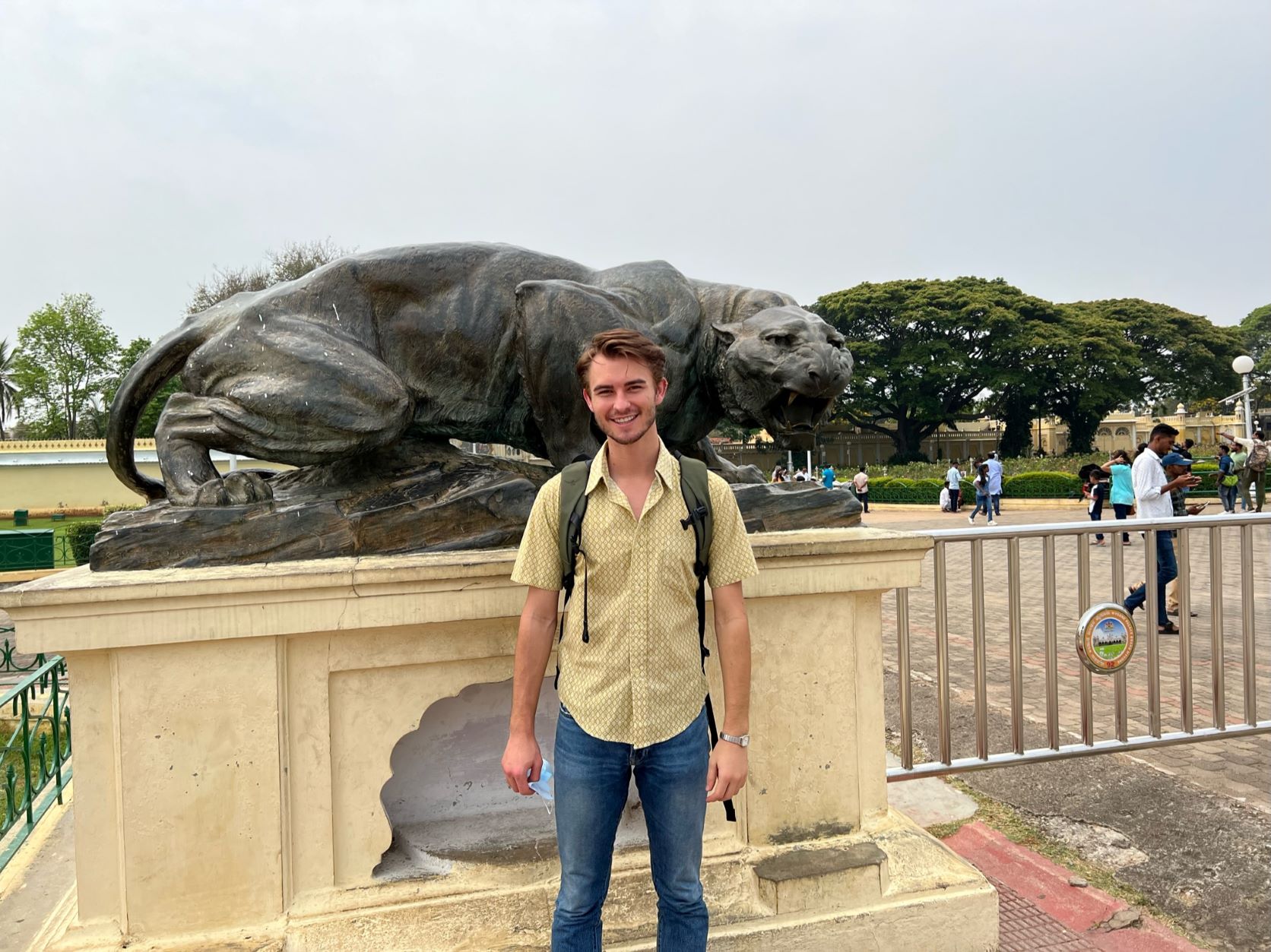 Paul Montgomery, an OSU student, standing in front of a statue in India.