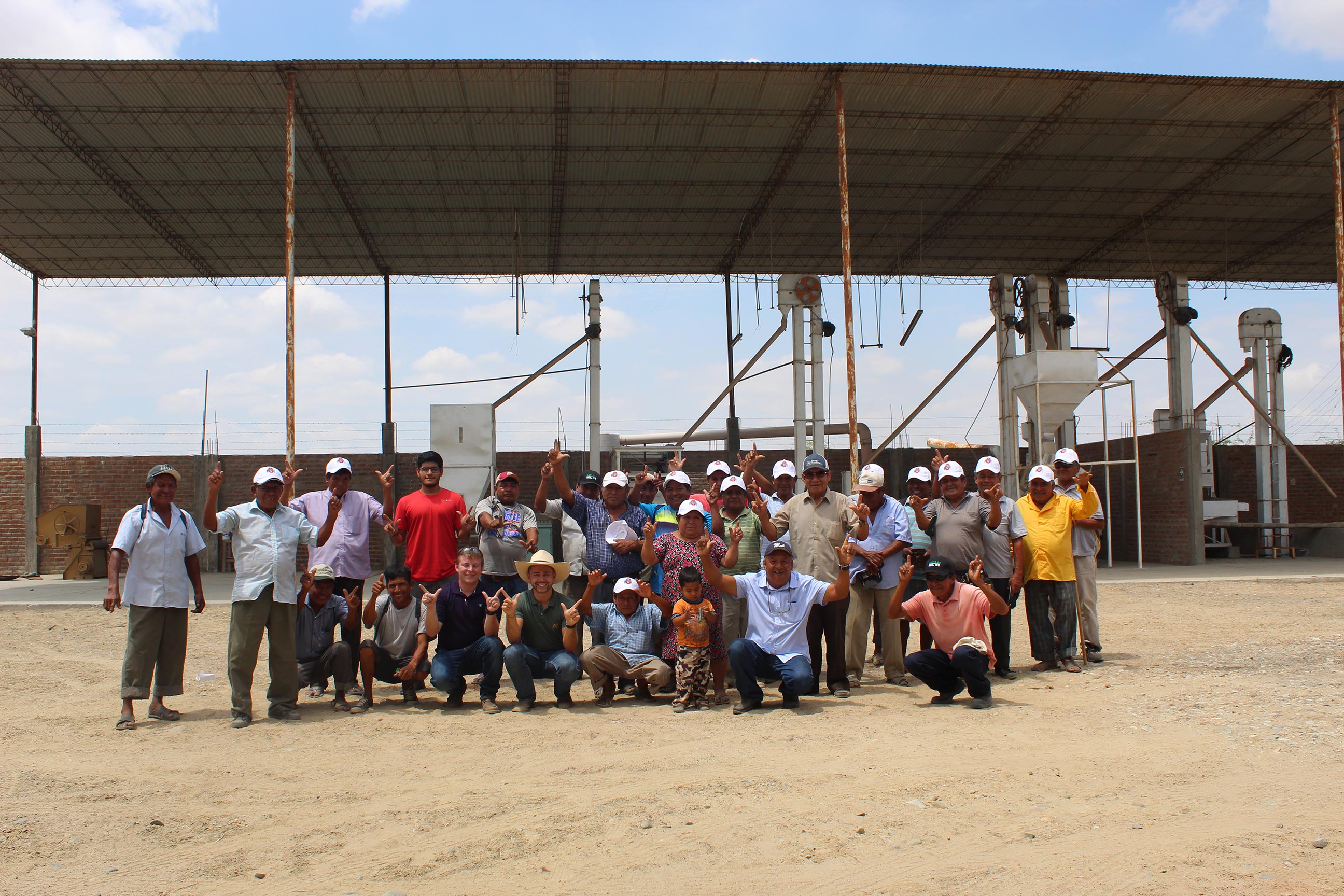Large group of people standing in front of a COOP in Peru.