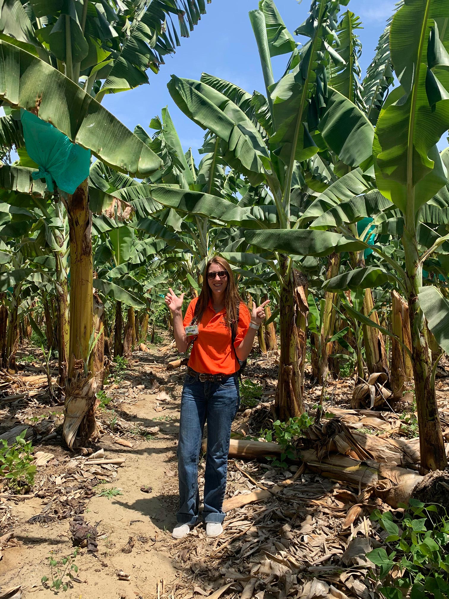 Student standing in a grove of trees in Peru.