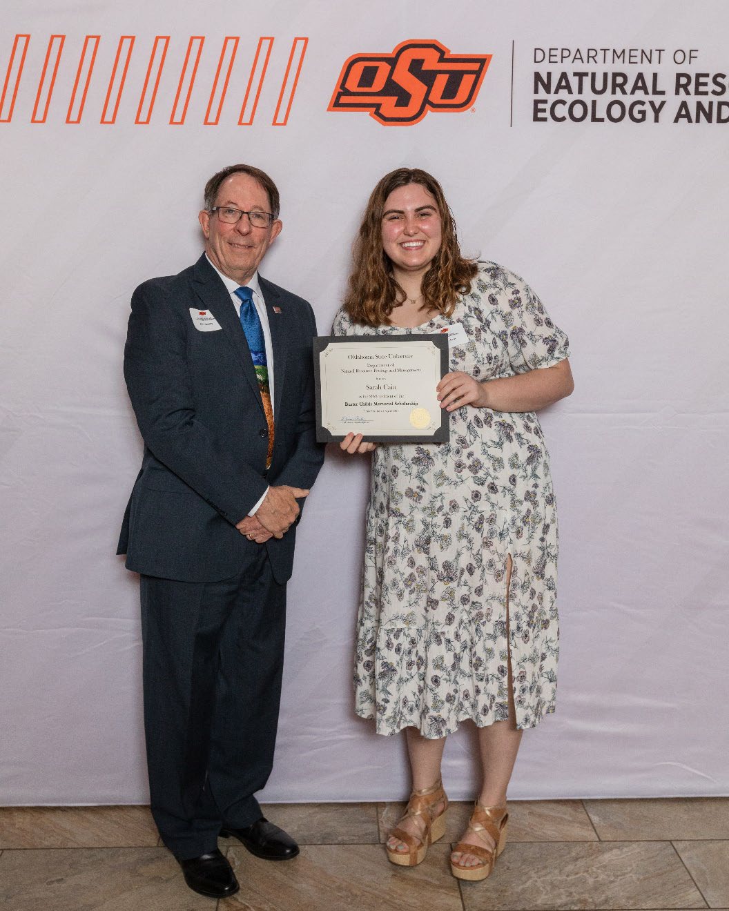 Sarah is accepting her award from Dr. Jim Ansley. Sarah is accepting her award from Dr. Jim Ansley.