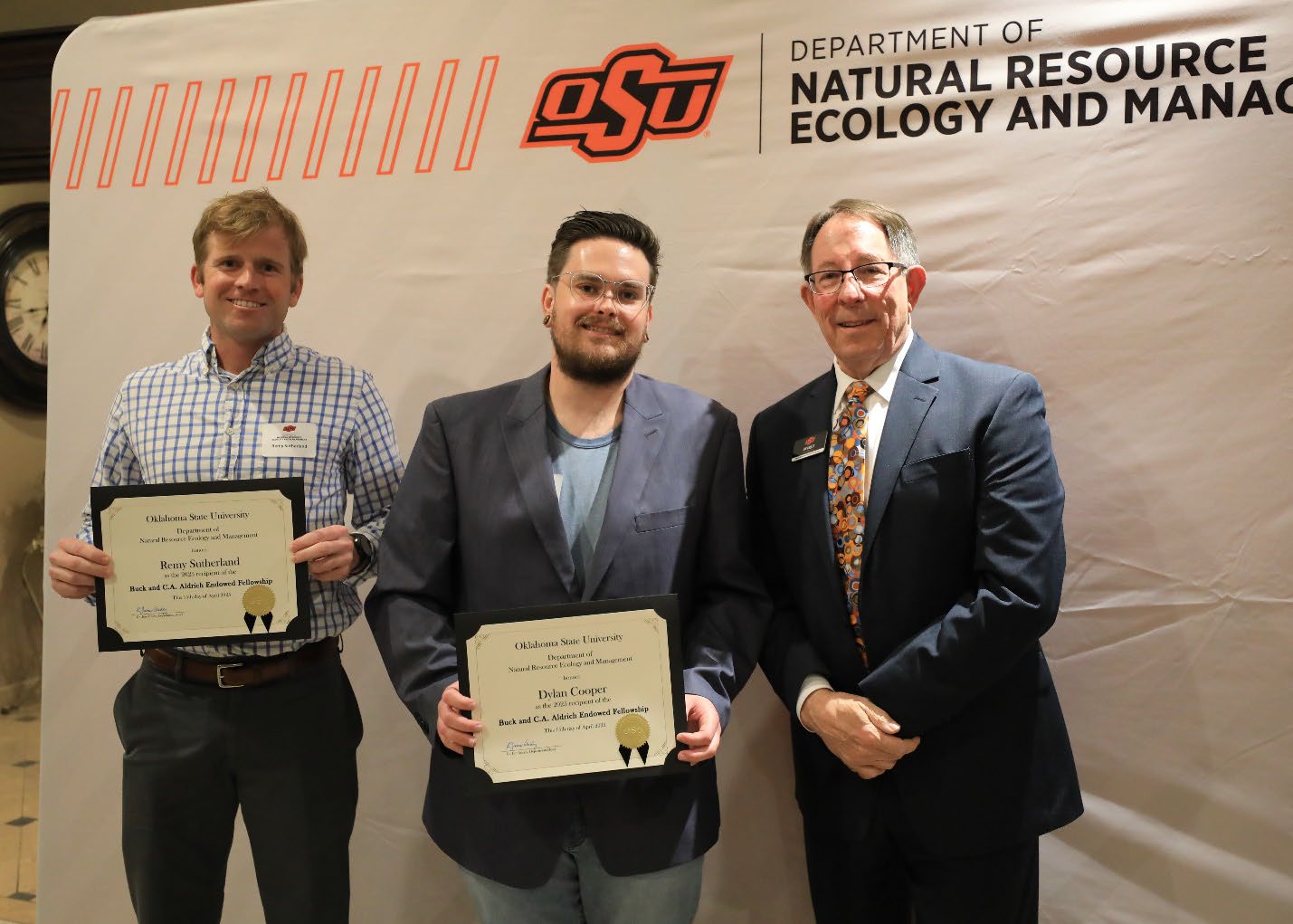 Remy Sutherland and Dylan Cooper holding their plaque next to Dr. Jim Ansley. Remy Sutherland and Dylan Cooper holding their plaque next to Dr. Jim Ansley.