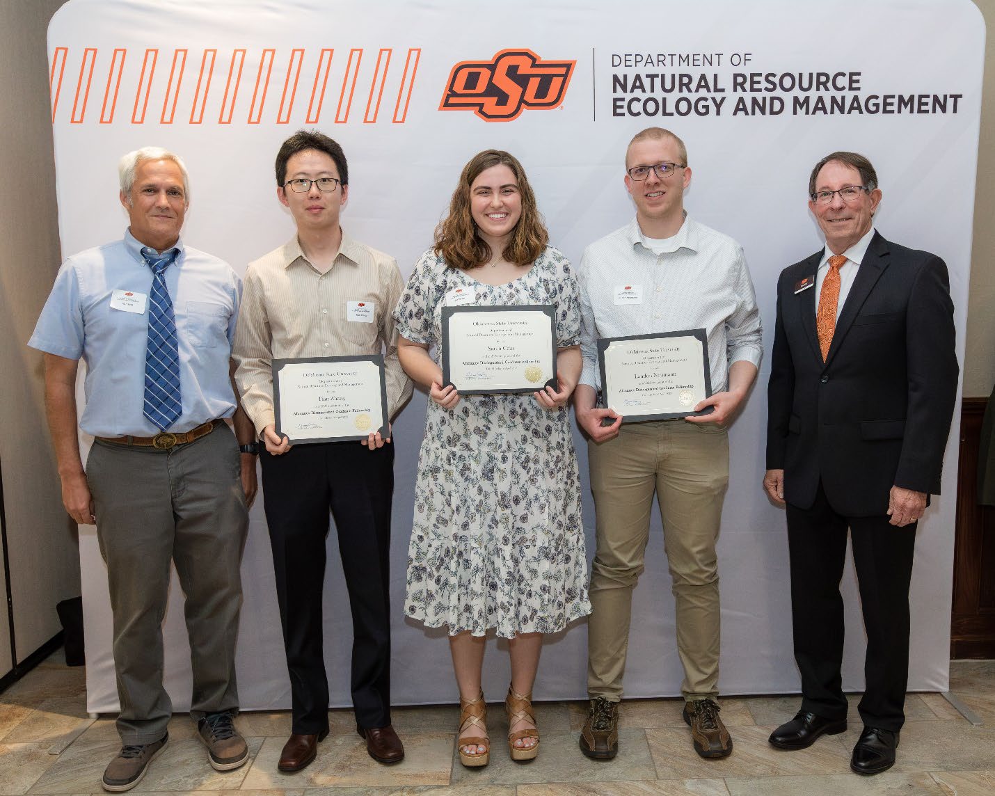 Jim Ansley and Rod Will next to Tian, Zhang and Landon accepting their Graduate Student Scholarship award.