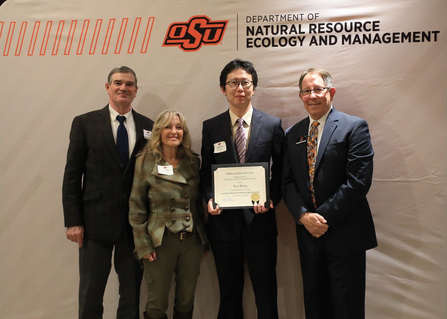 Tian Zhang holding his award with Louise and Bruce Burton and Dr. Jim Ansley. Tian Zhang holding his award with Louise and Bruce Burton and Dr. Jim Ansley.
