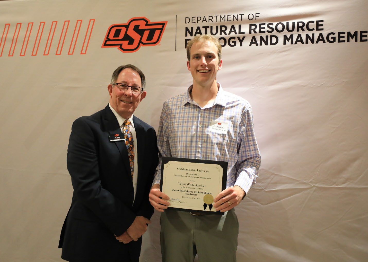 Wyatt Wolfenkoehler holding his plaque next to Dr. Jim Ansley. Wyatt Wolfenkoehler holding his plaque next to Dr. Jim Ansley.