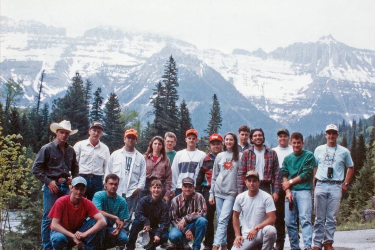 A group of people standing outside posing for a photo.