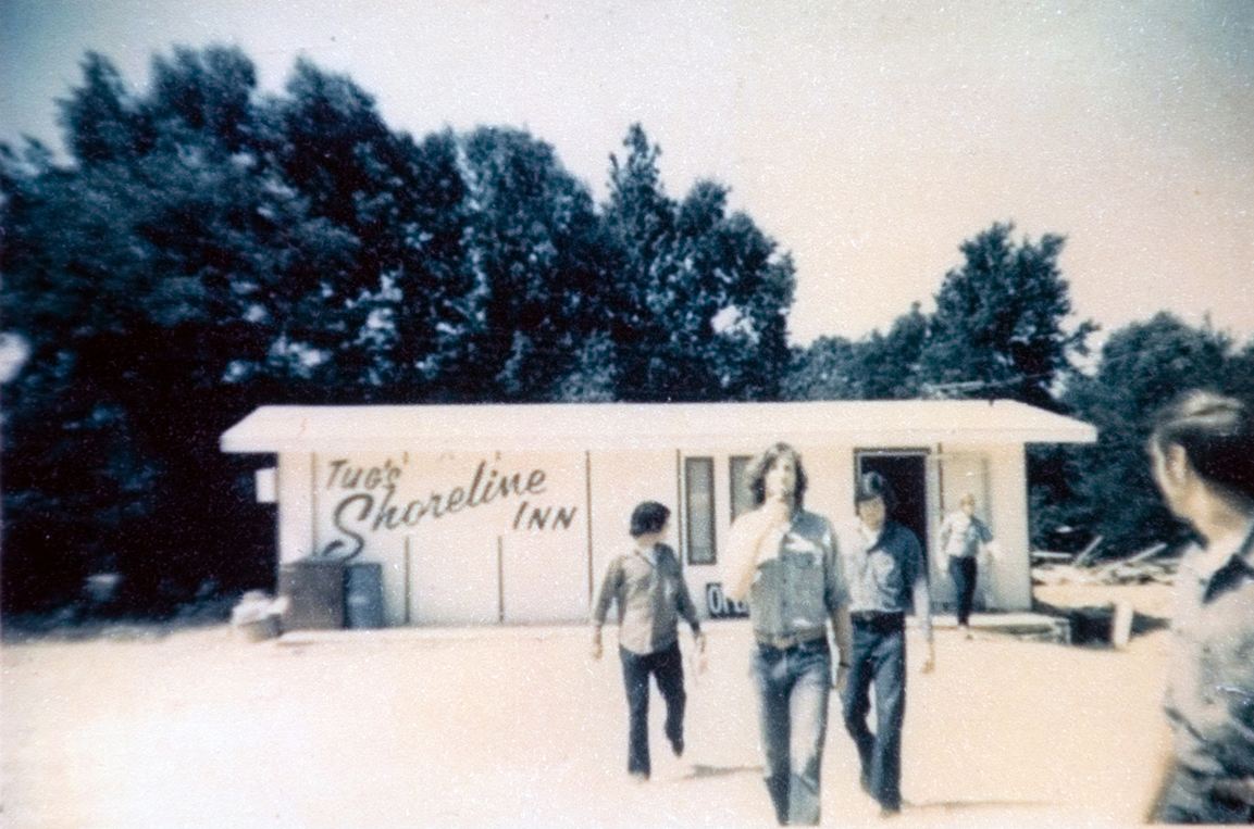 Three students walking away form the Shoreline Inn building.