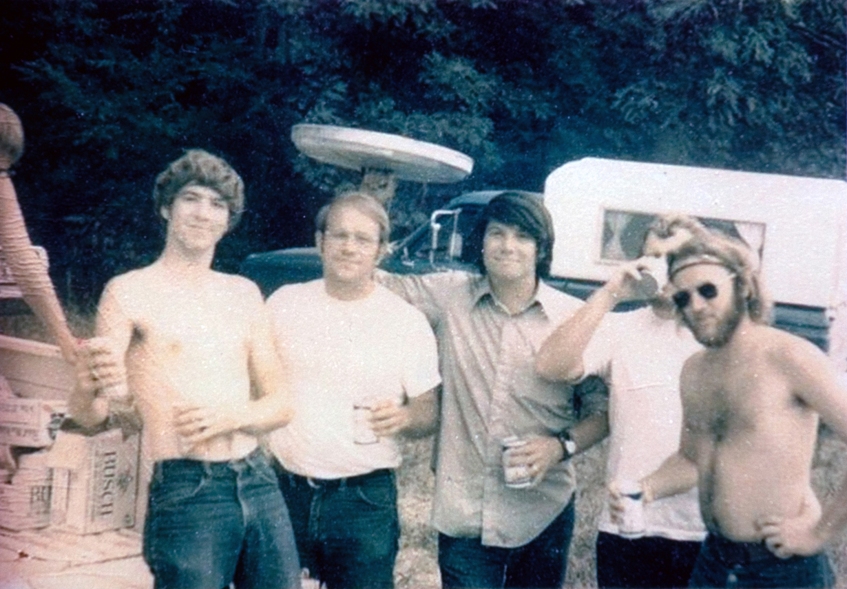 Fixe students standing together, drinking from a can.