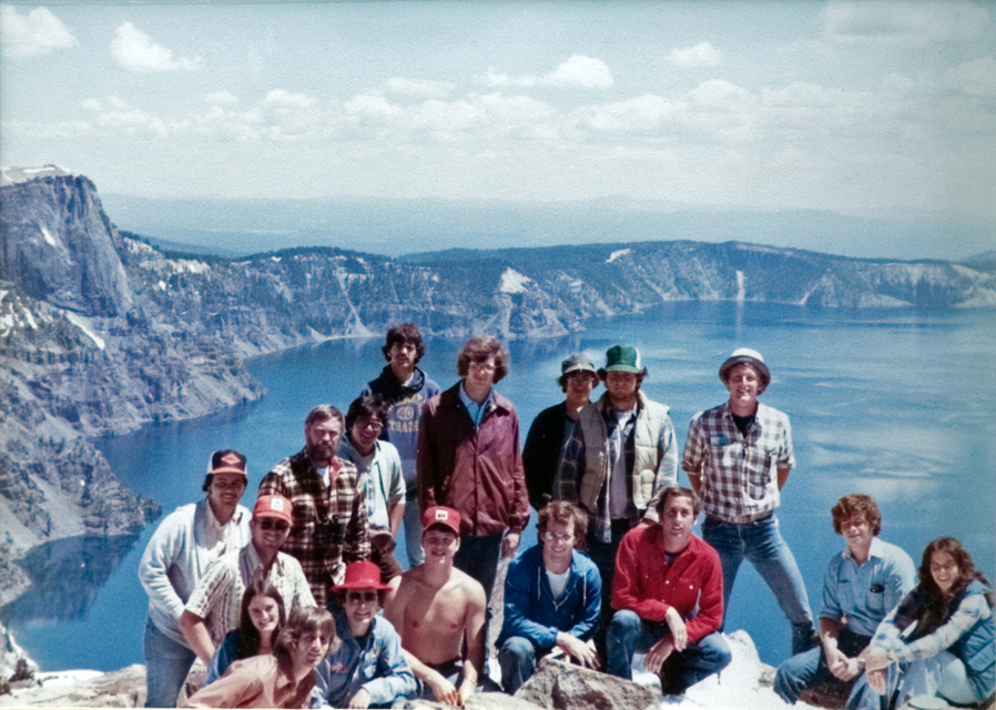 Students pose for the camera with lake and mountains serving as their backdrop.