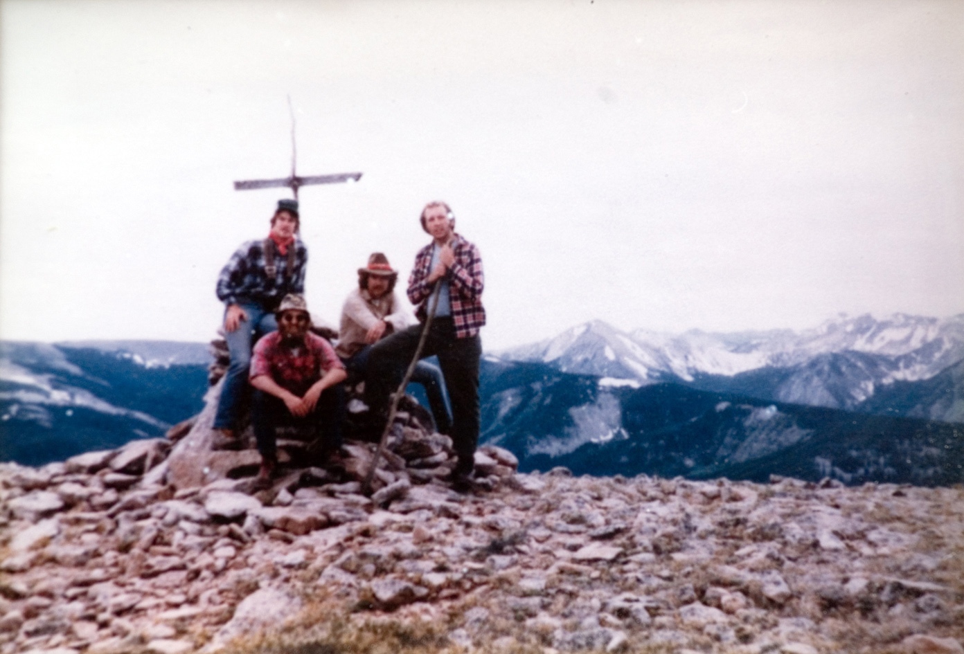 Four students pose for a photo by a mountain trail.
