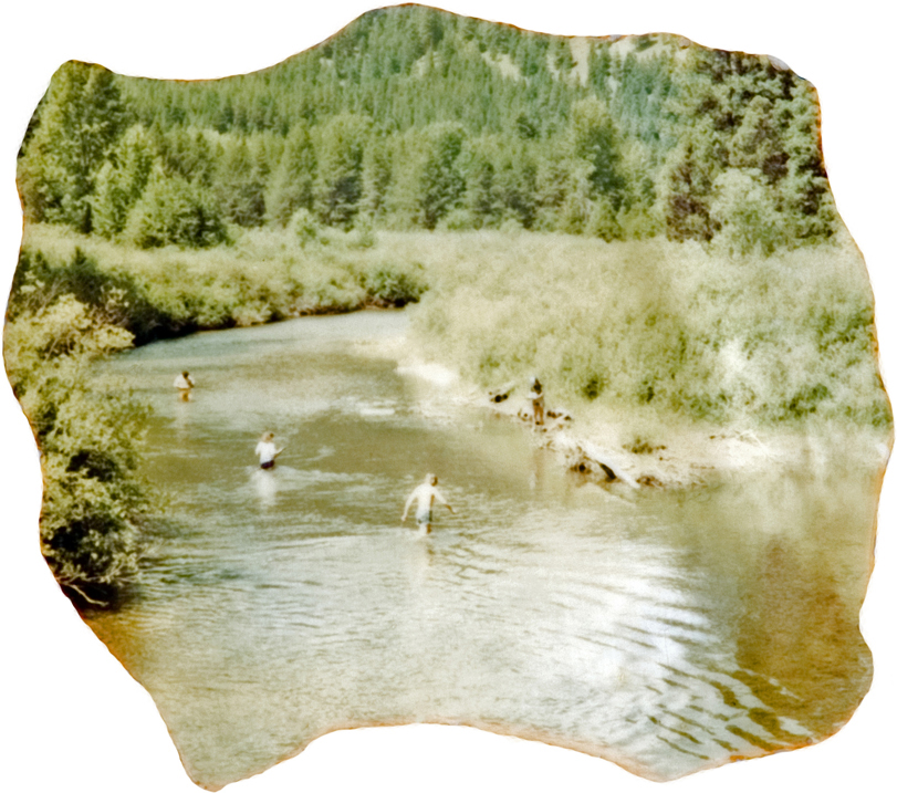 A group of people hanging out in a stream.