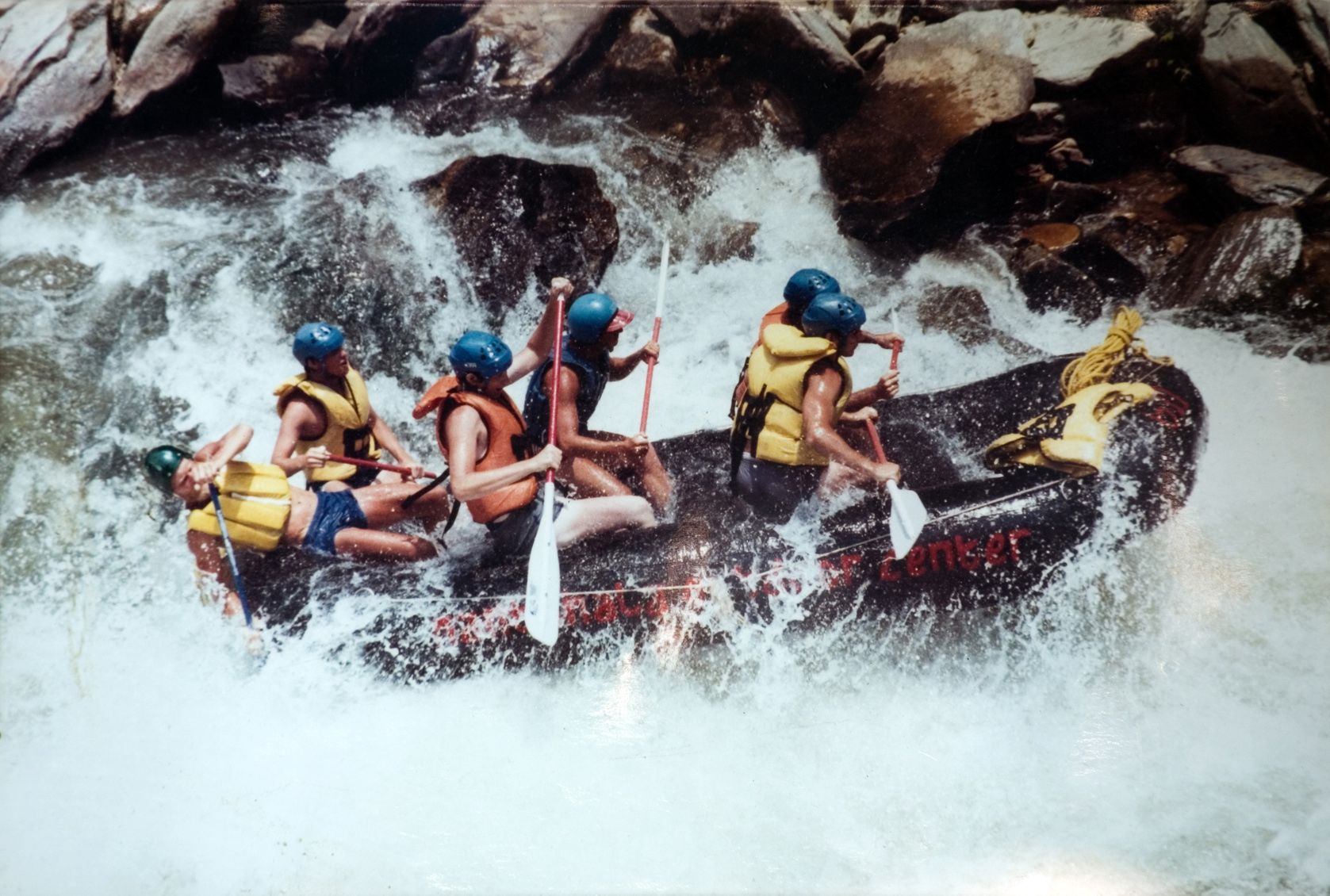 Five students rafting down a river.