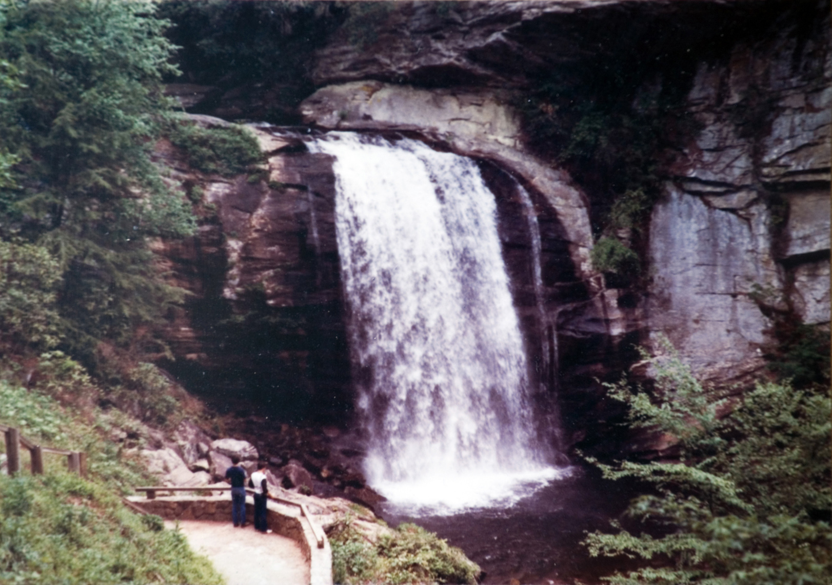 Two people looking at a waterfall.