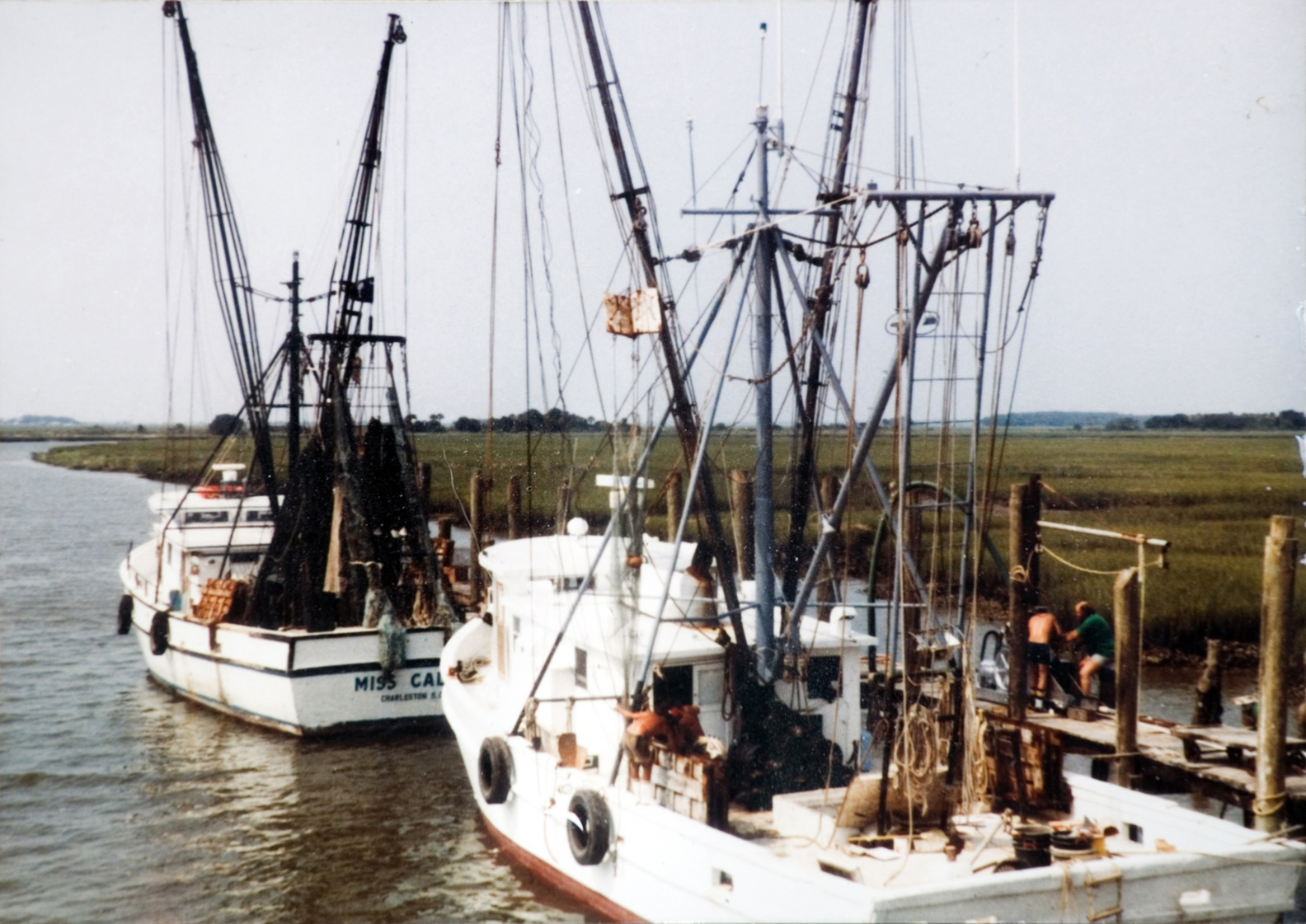 Two boats docked on a river.
