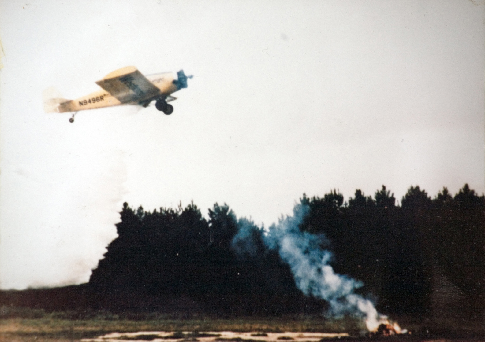 A small plane flying over a campsite.