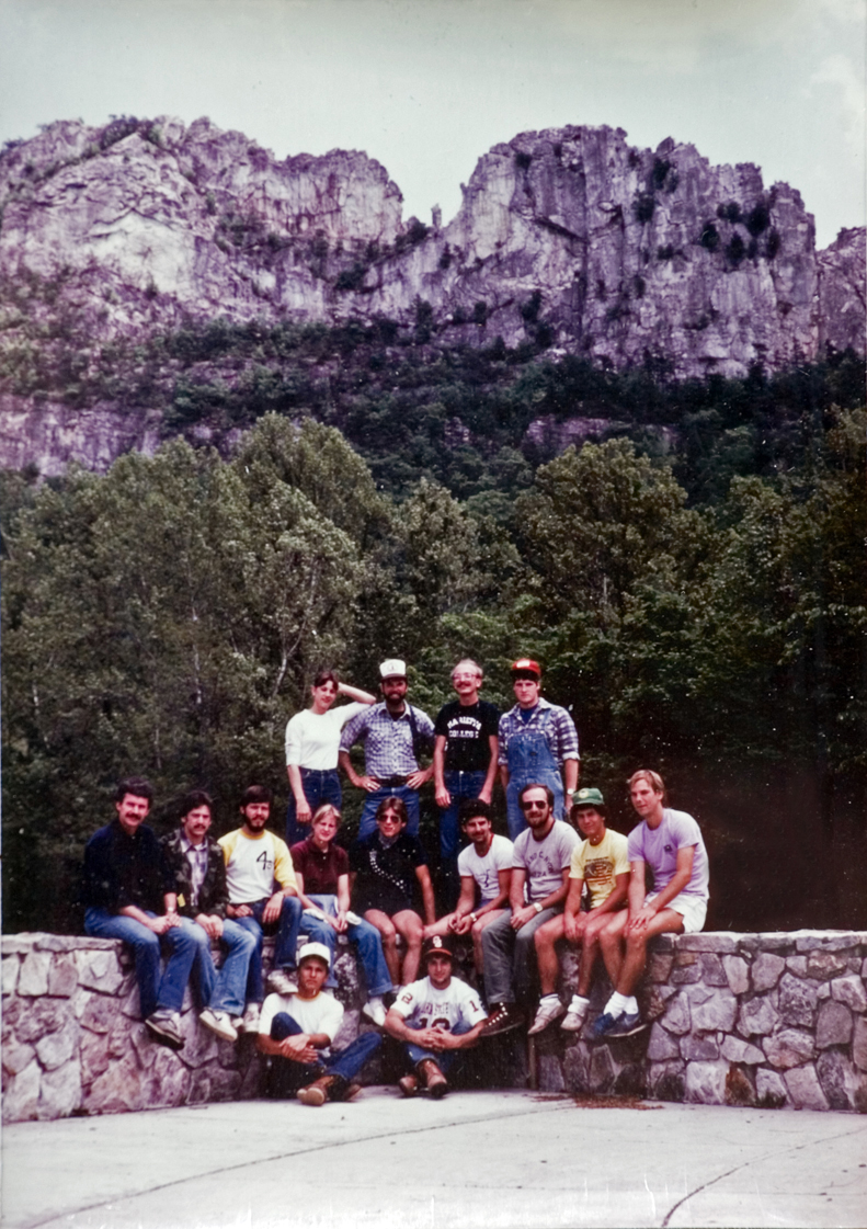 The forestry camp group gathers for a photo against a mountain backdrop.