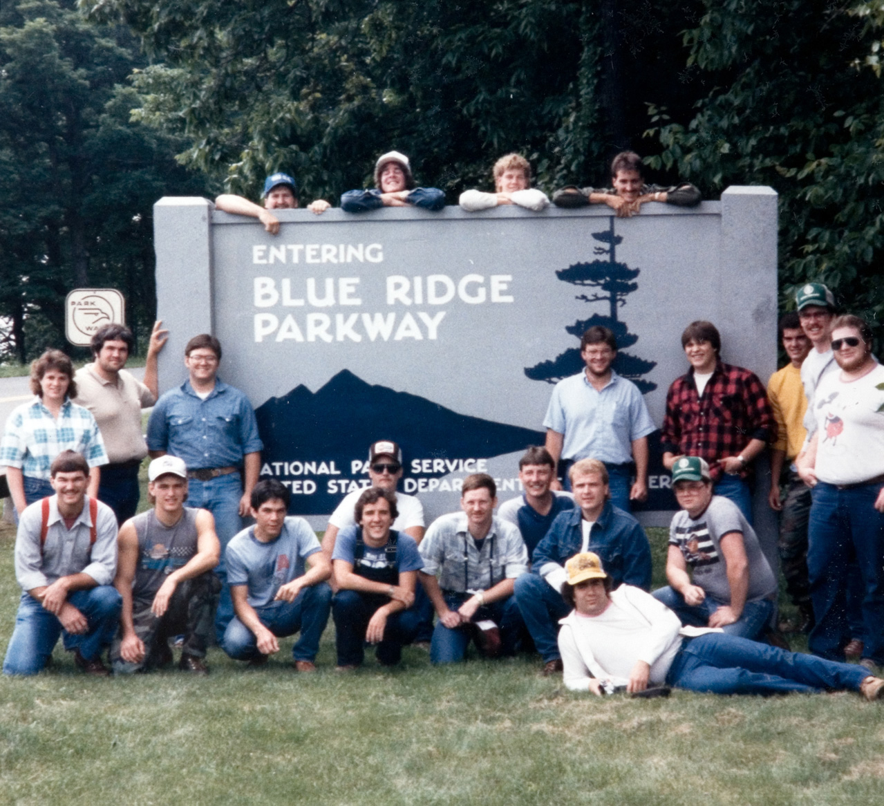 A group of 22 students standing outside of the Blue Ridge Parkway sign for their photo to be taken.