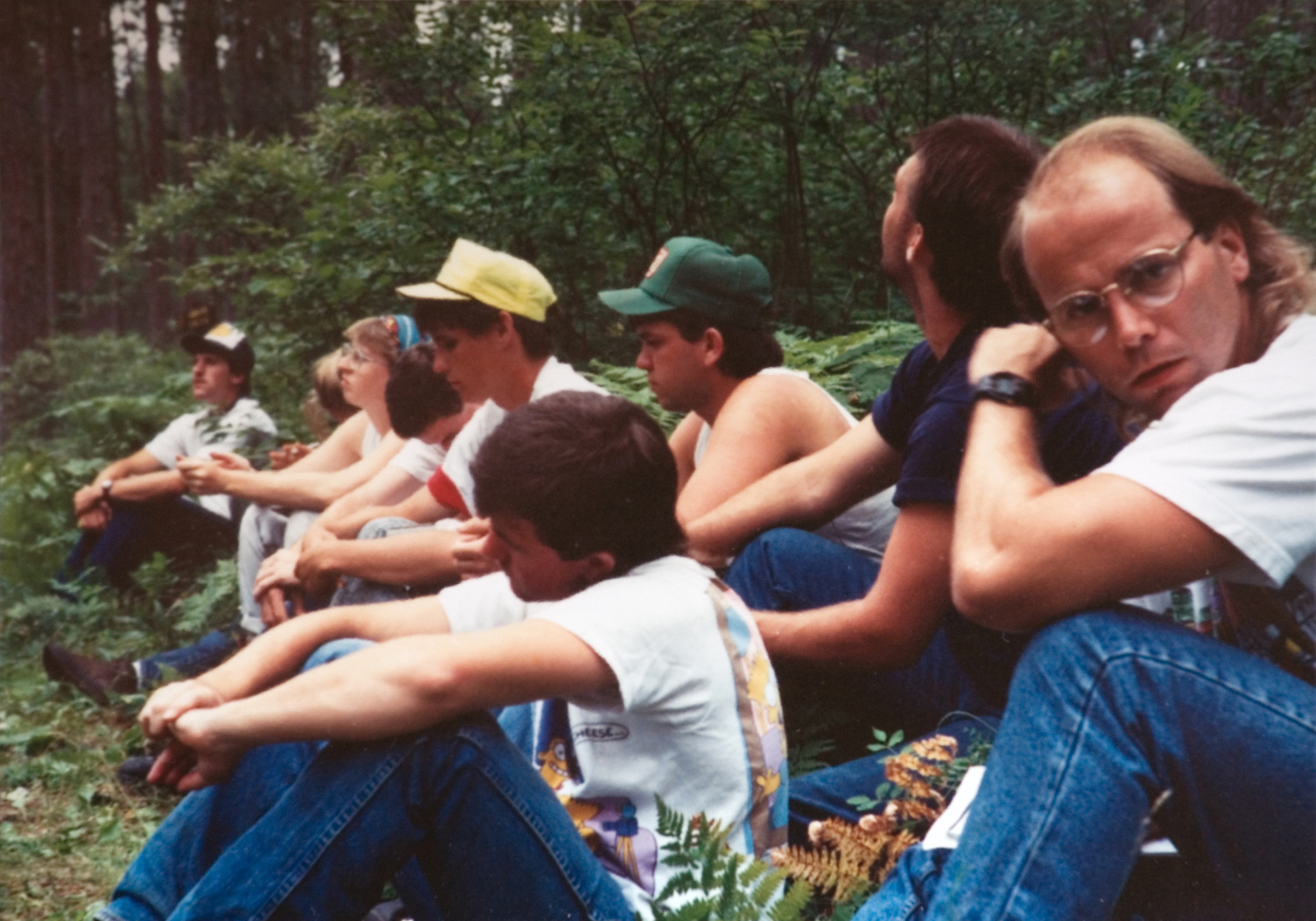 Students sit down to take a break in the forest.