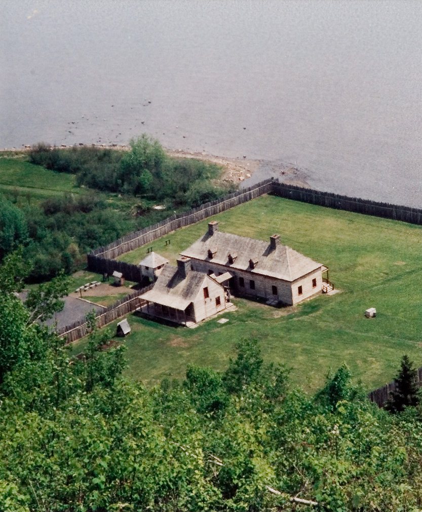 Aerial view of the camp grounds next to a lake. 