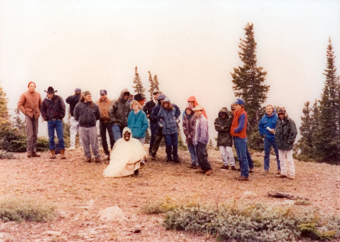 Students get together on a hill to prepare for a hike.
