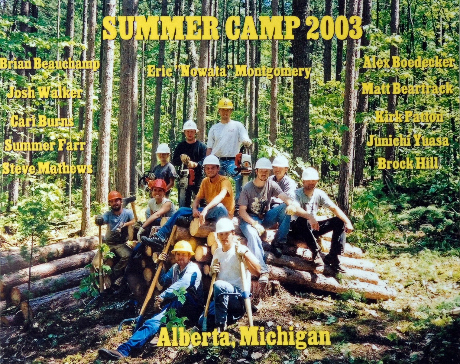 The 2003 Forestry Camp group photo of participants in hardhats in the woods.