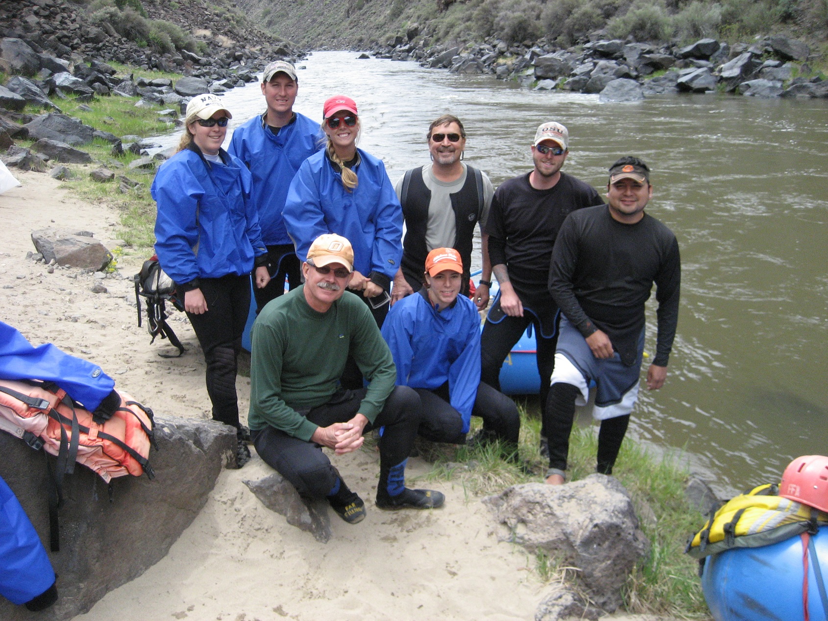 A group of participants standing next to a river. 