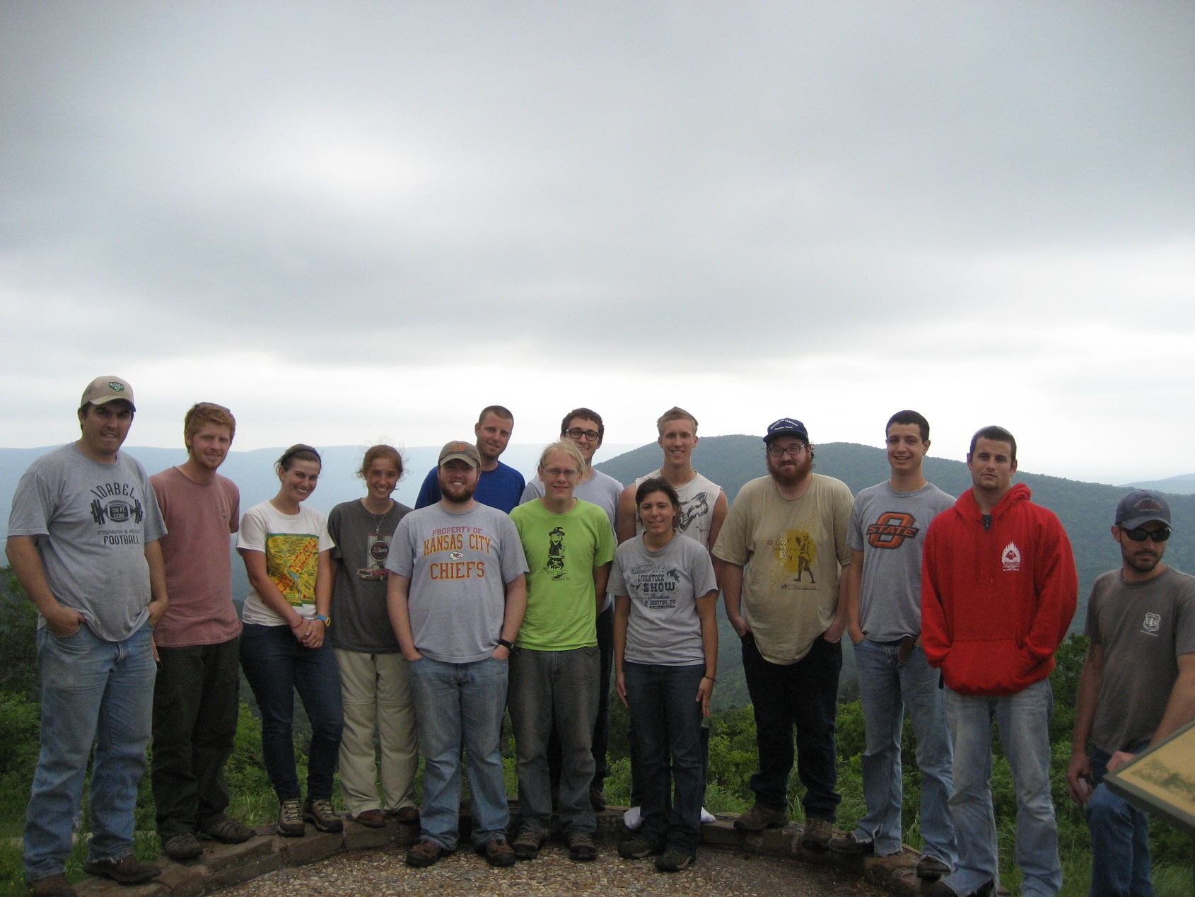 A large group of students standing at an overlook of a mountain range. A large group of students standing at an overlook of a mountain range.