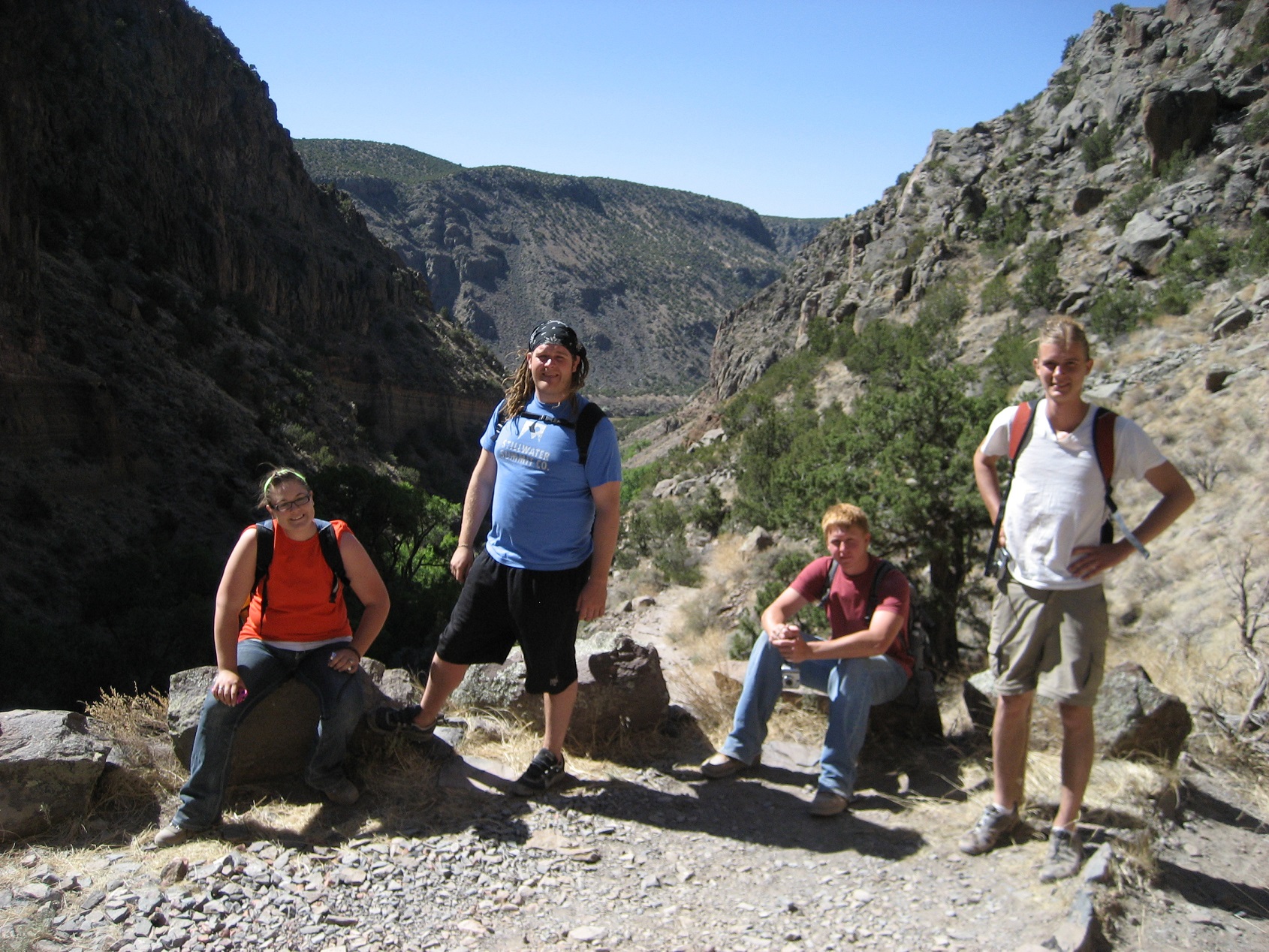 Four participants sitting in a valley between two mountains. Four participants sitting in a valley between two mountains.