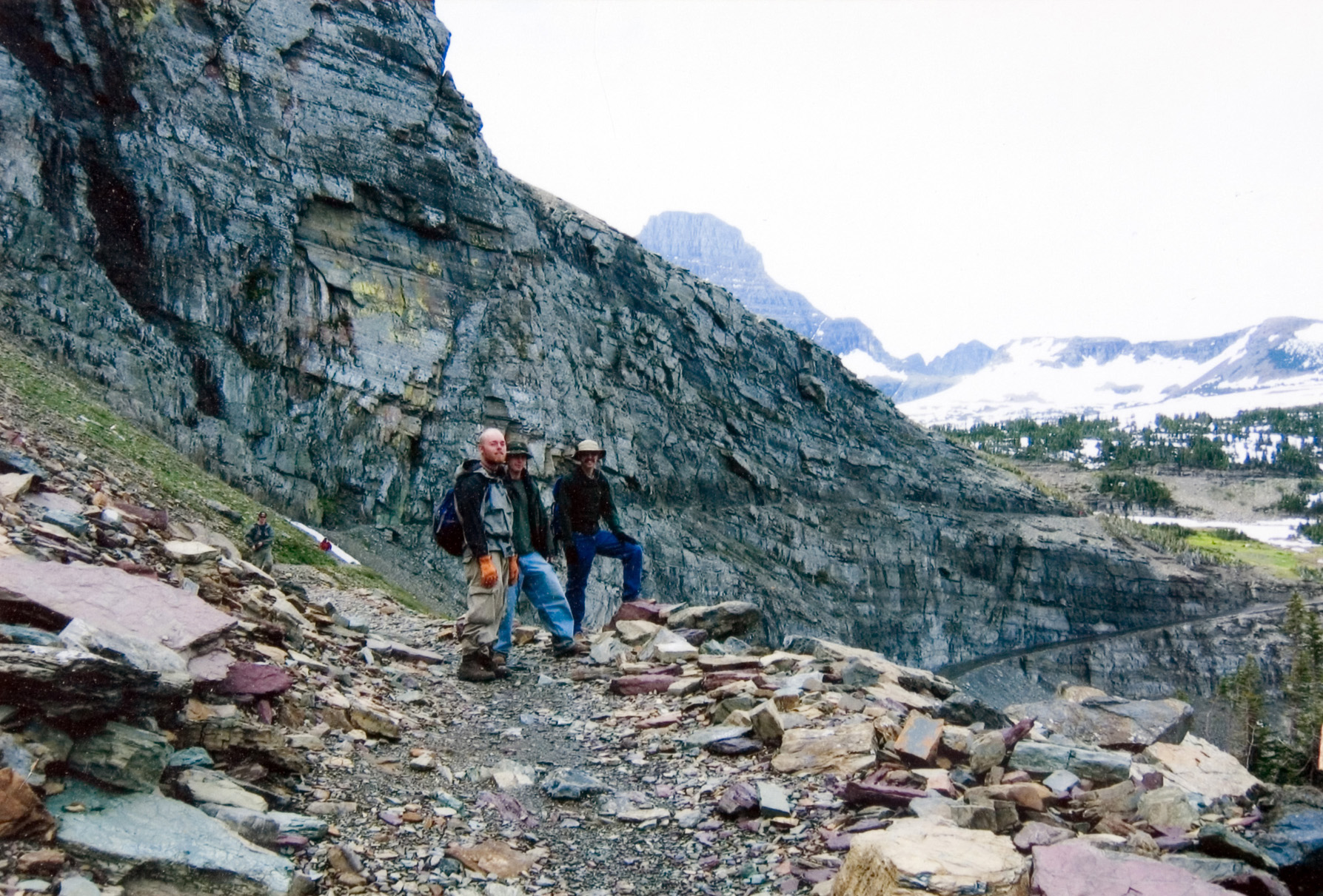 Students stop to look ahead on a hiking trail.