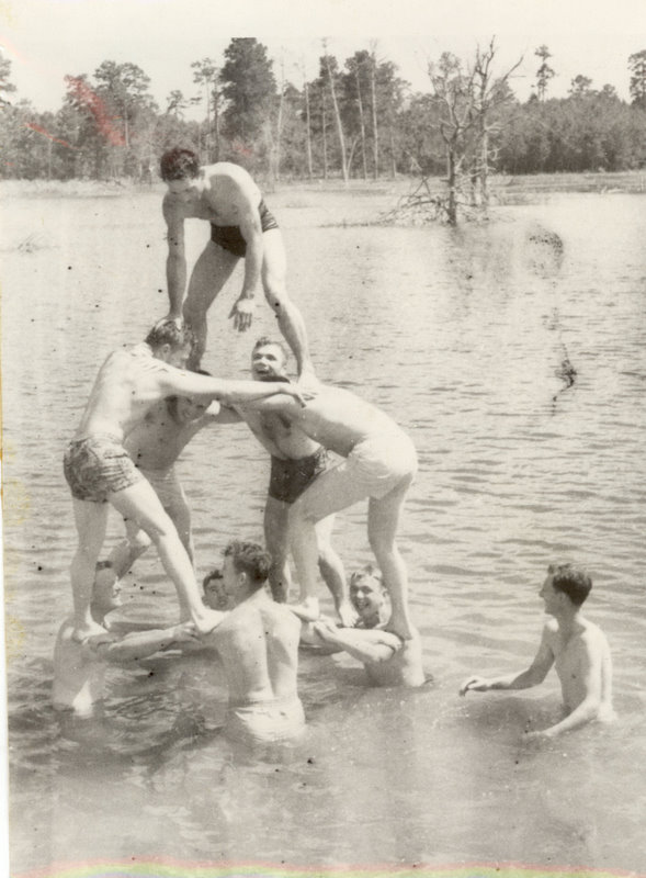 Students are in the water trying to create a pyramid formation.