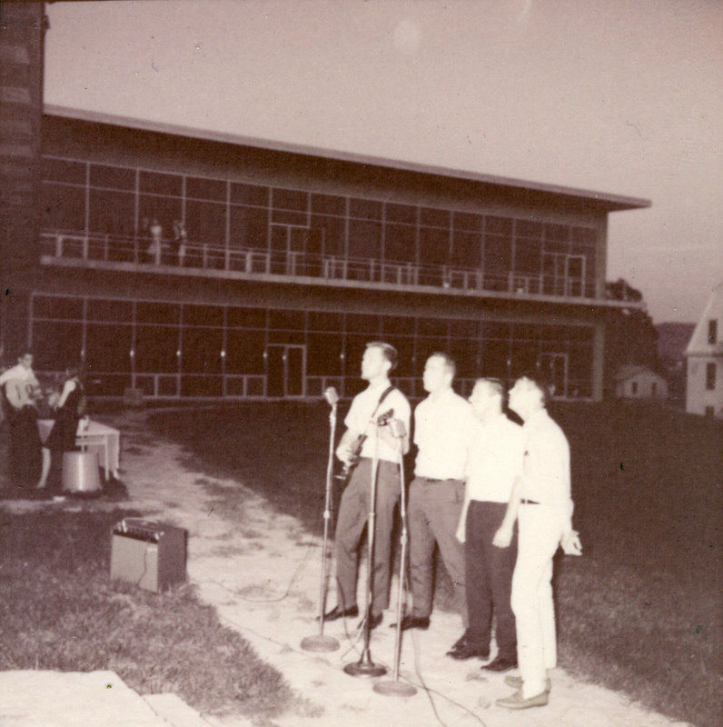 A group of people outside speaking at a microphone. A group of people outside speaking at a microphone.