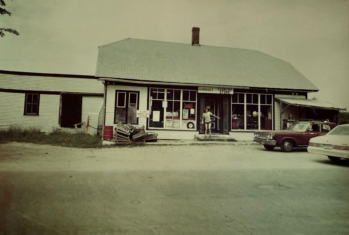 A kid coming out of a store with two cars parked out front. A kid coming out of a store with two cars parked out front.