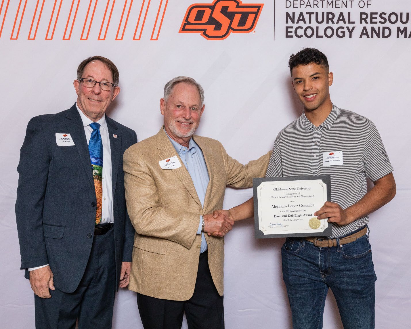 Alejandro accepting his award with Dave and Dr. Jim Ansley.
