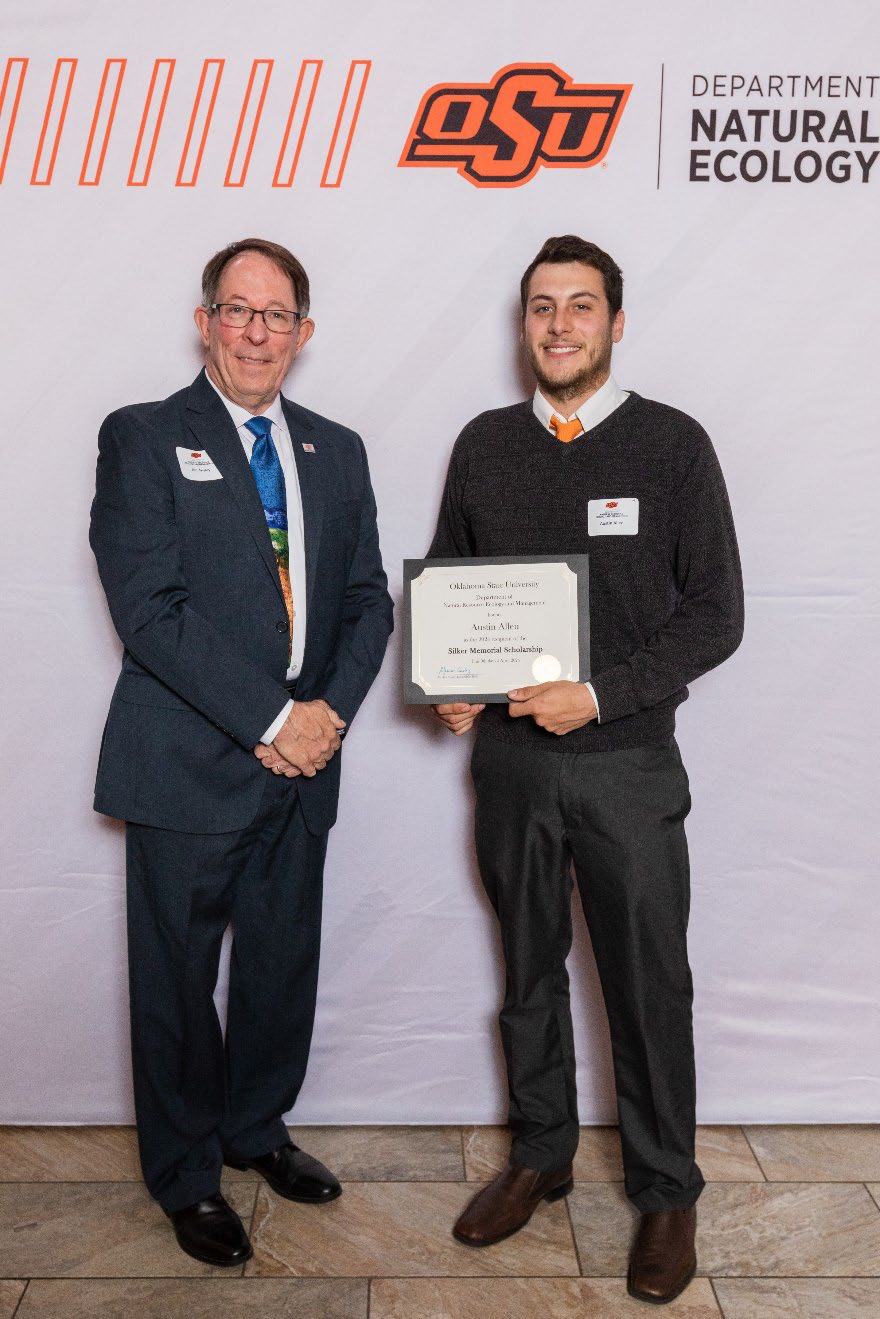 Austin holding his award next to Dr. Jim Ansley.