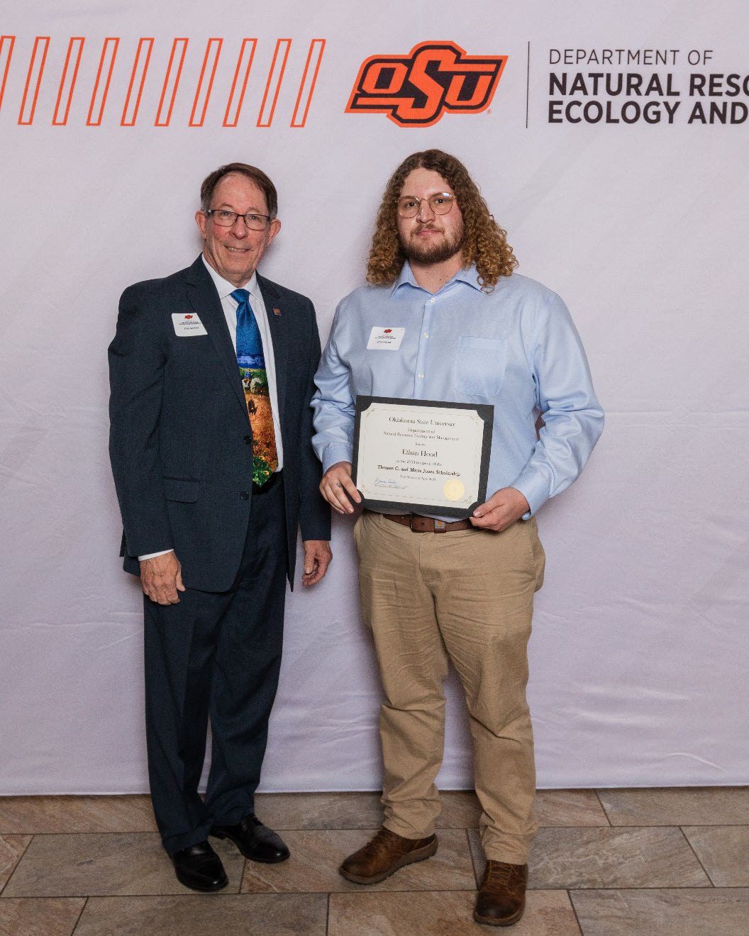 Ethan showing his award with Dr. Jim Ansley.