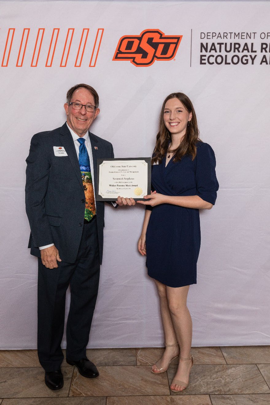 Savannah is accepting her award from Dr. Jim Ansley.