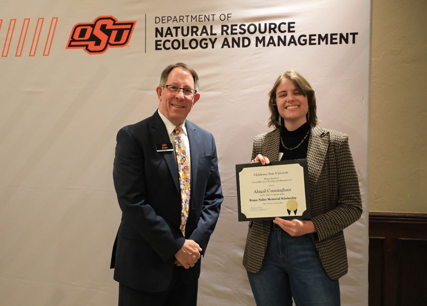 Abigail Cunningham with her plaque next to Dr. Jim Ansley.