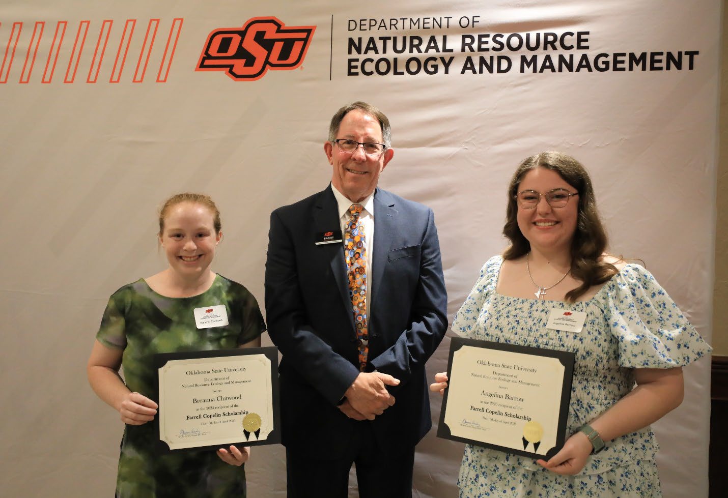 Breanna Chitwood and Angelina Barrow showing off their scholarship award next to Dr. Jim Ansley.