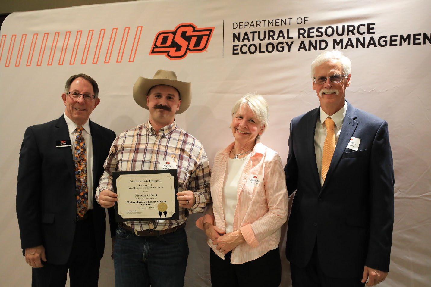 Nicholas O’Neil holding his award with Mia and Keith and Dr. Jim Ansley..