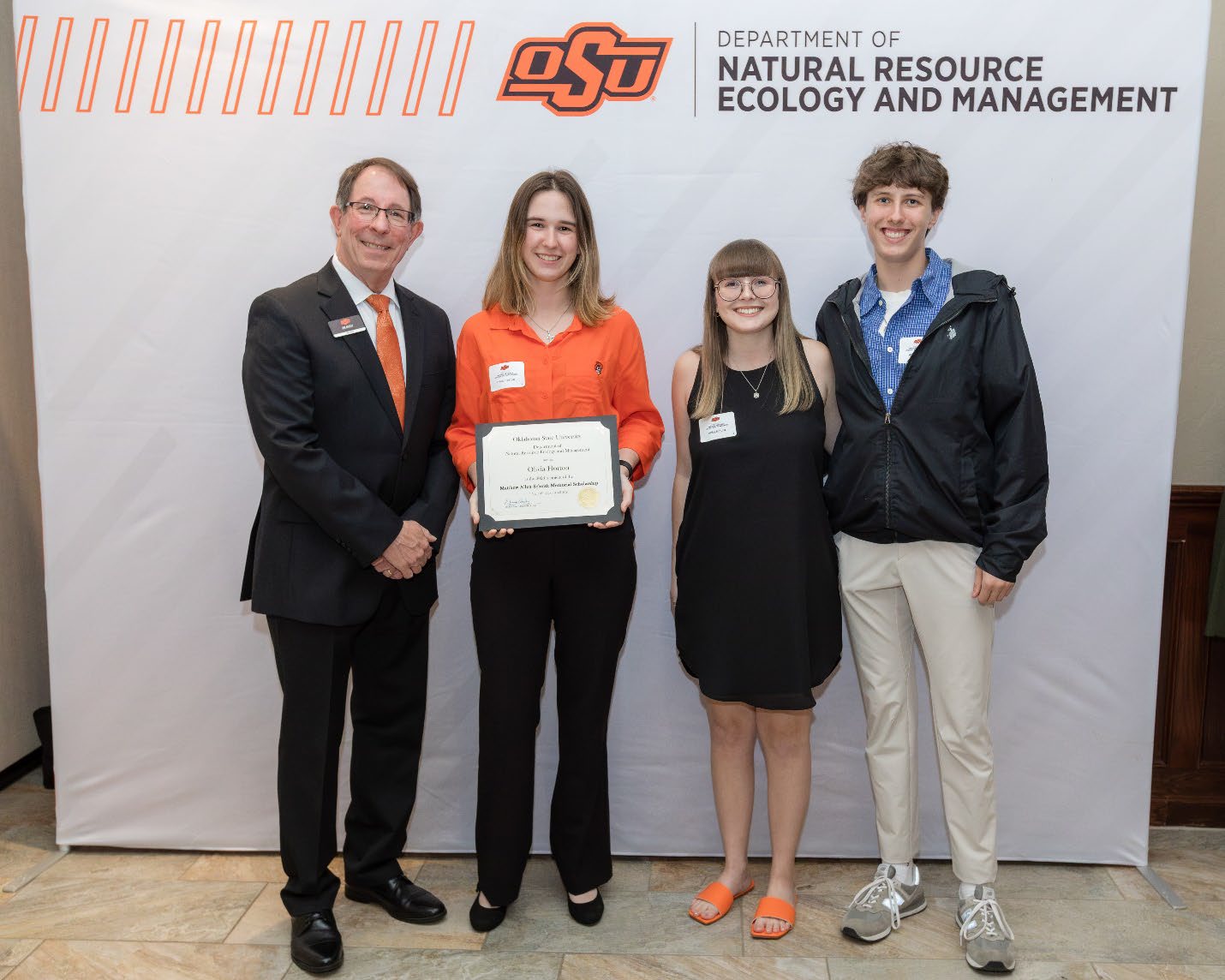 Oliver and Donors with Jim Ansley accepting their Undergraduate Student Scholarship award.