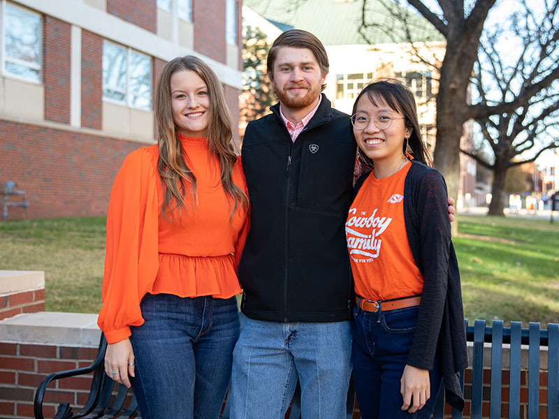 Three student success leaders standing outside of Legacy Hall.